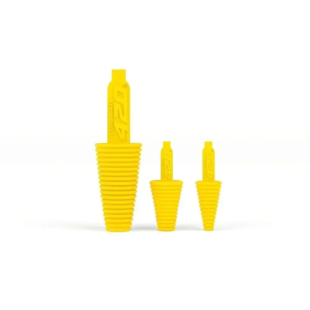 Three yellow silicone cleaning plugs for glass pipes or water pipes.