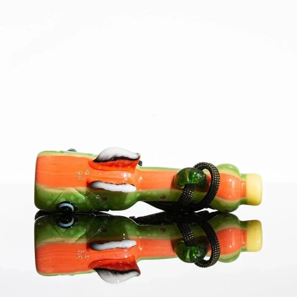 Colorful glass fish-shaped whistle with green, orange, and yellow details on white background