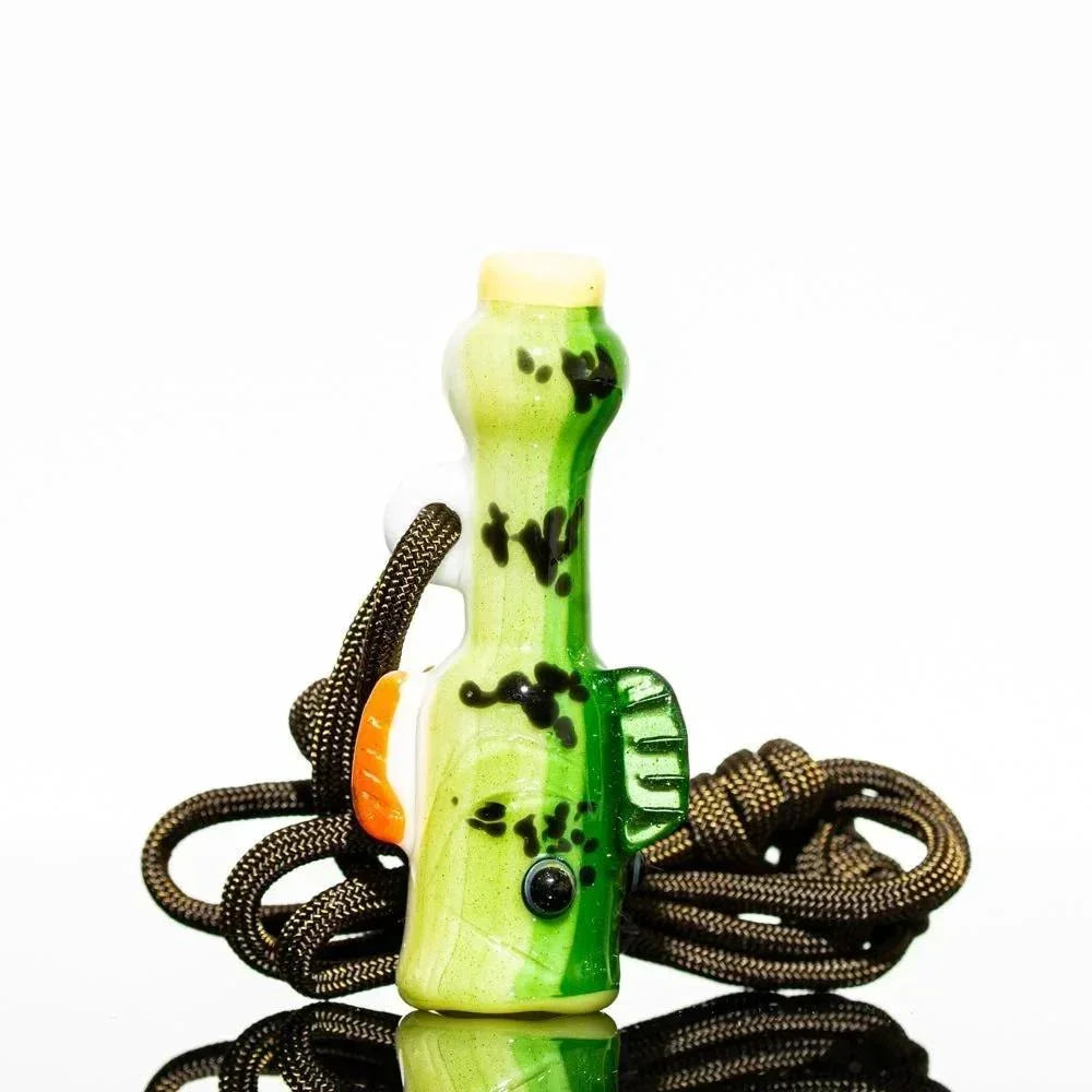 Handmade green glass fish-shaped whistle with brown cord on white background