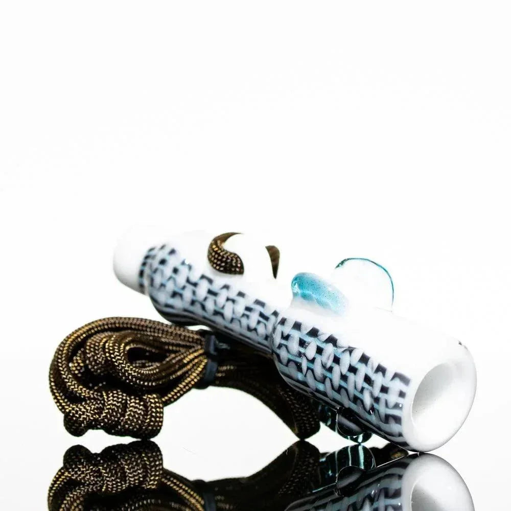 Hand-blown glass pipe with woven pattern, blue accent, and textured grip on reflective surface