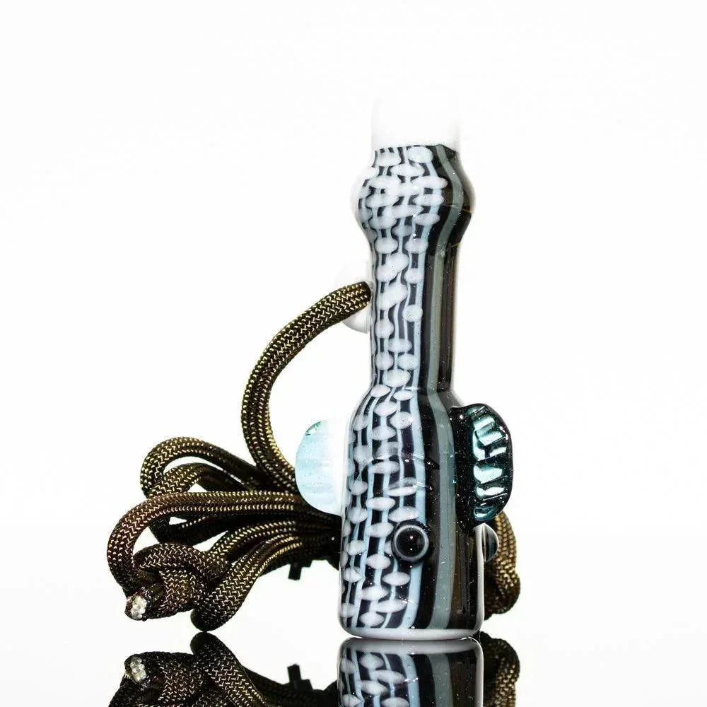 Handcrafted glass pipe with black, white, and teal patterns, featuring a textured design and braided cord.