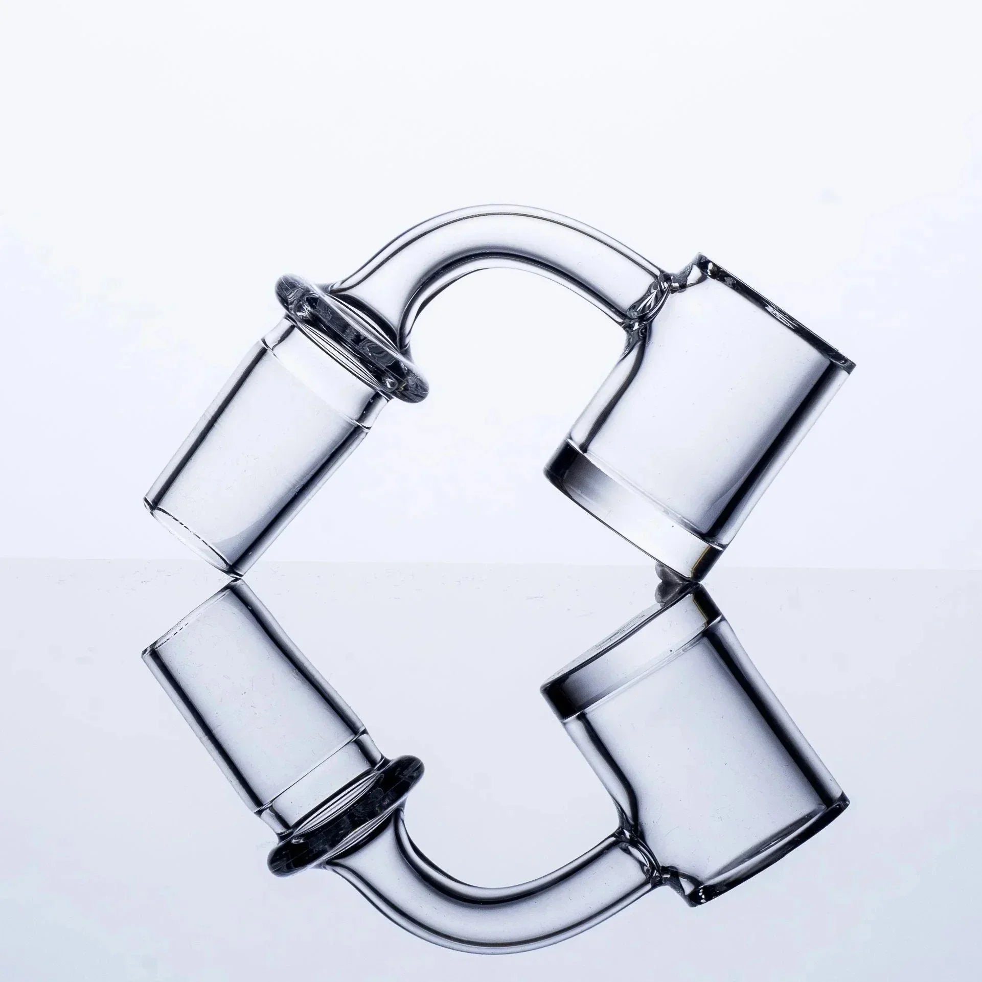 Clear glass smoking accessory with curved tube and dual chambers, reflective surface