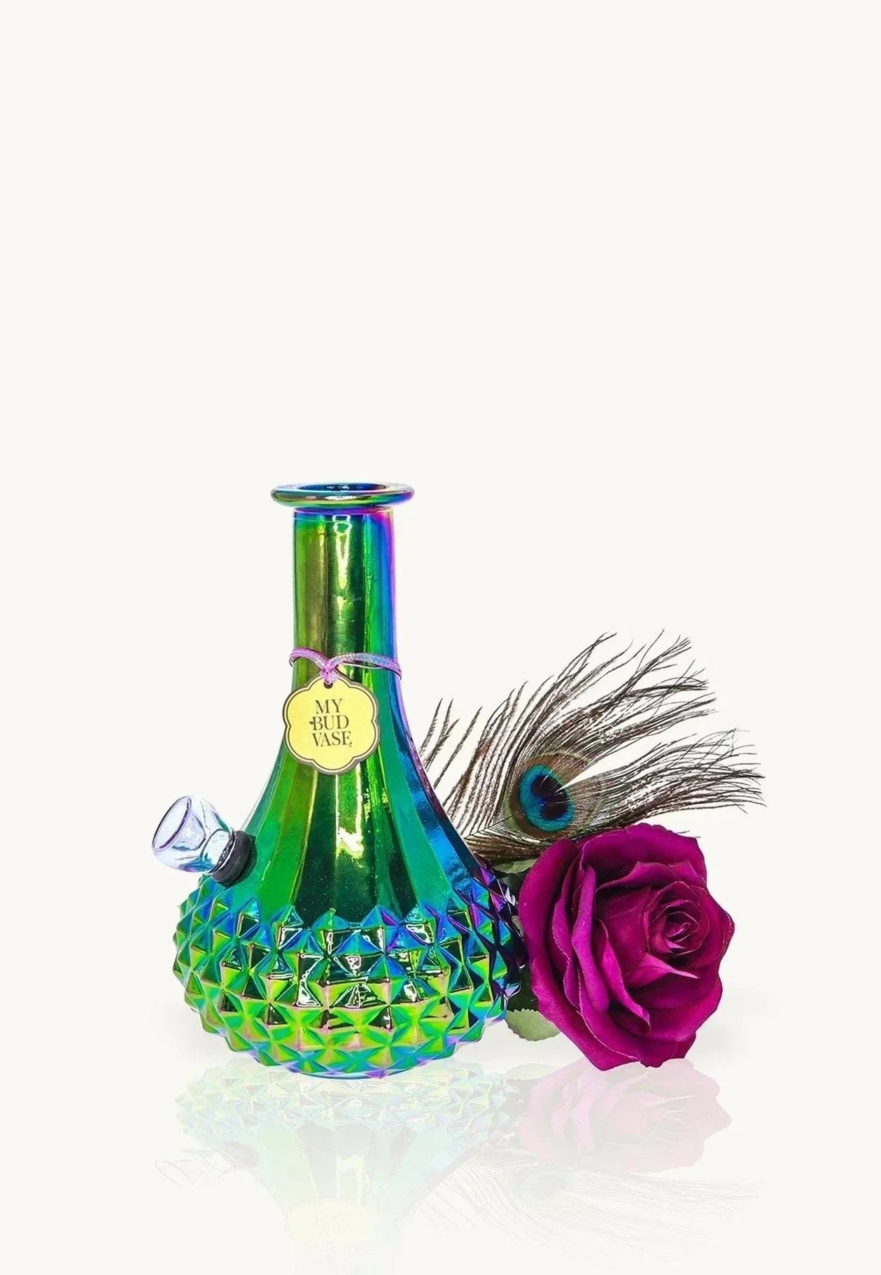 Iridescent glass vase pipe with geometric pattern, peacock feather, and magenta rose accent.