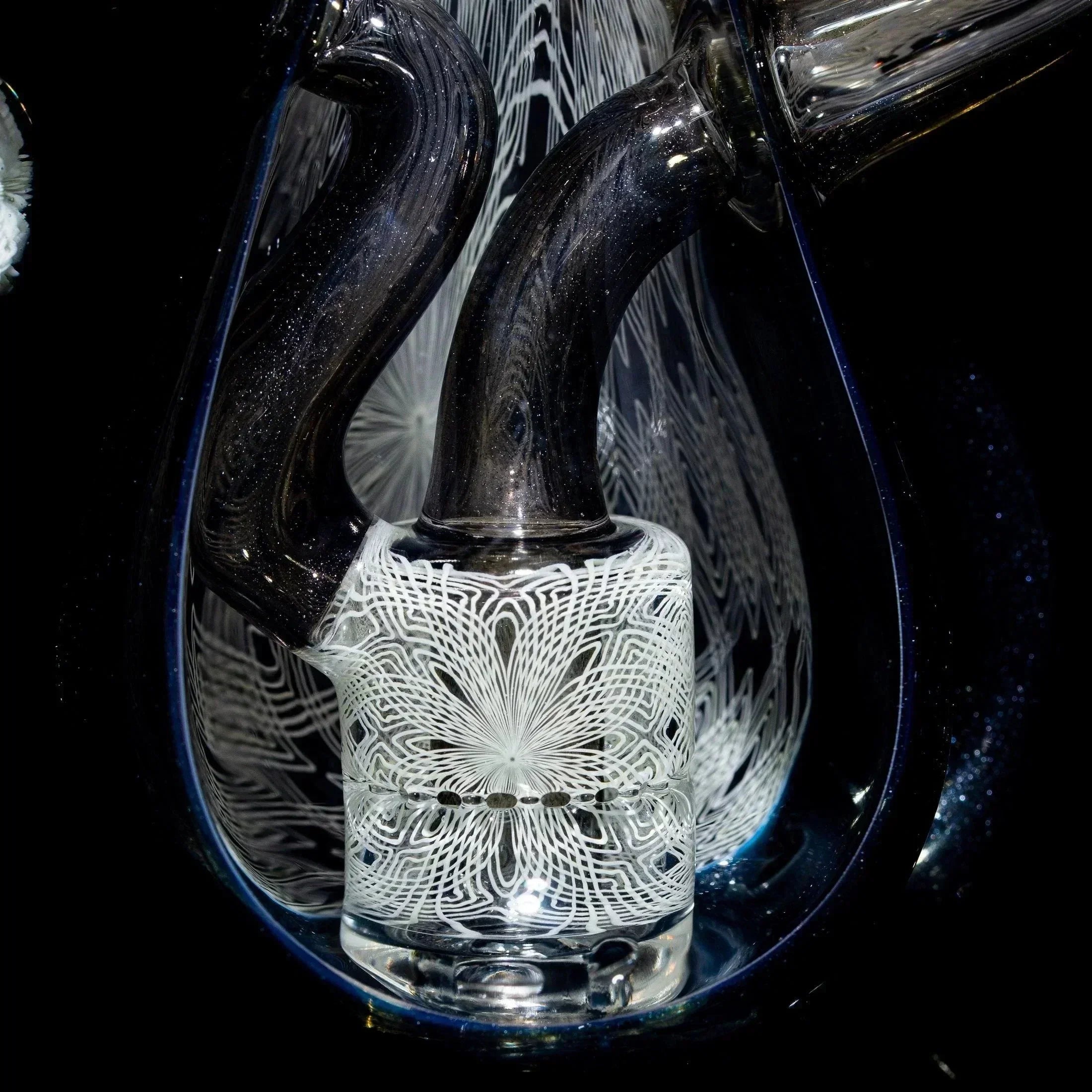 Intricate heady glass artwork with swirling black and white detailed patterns