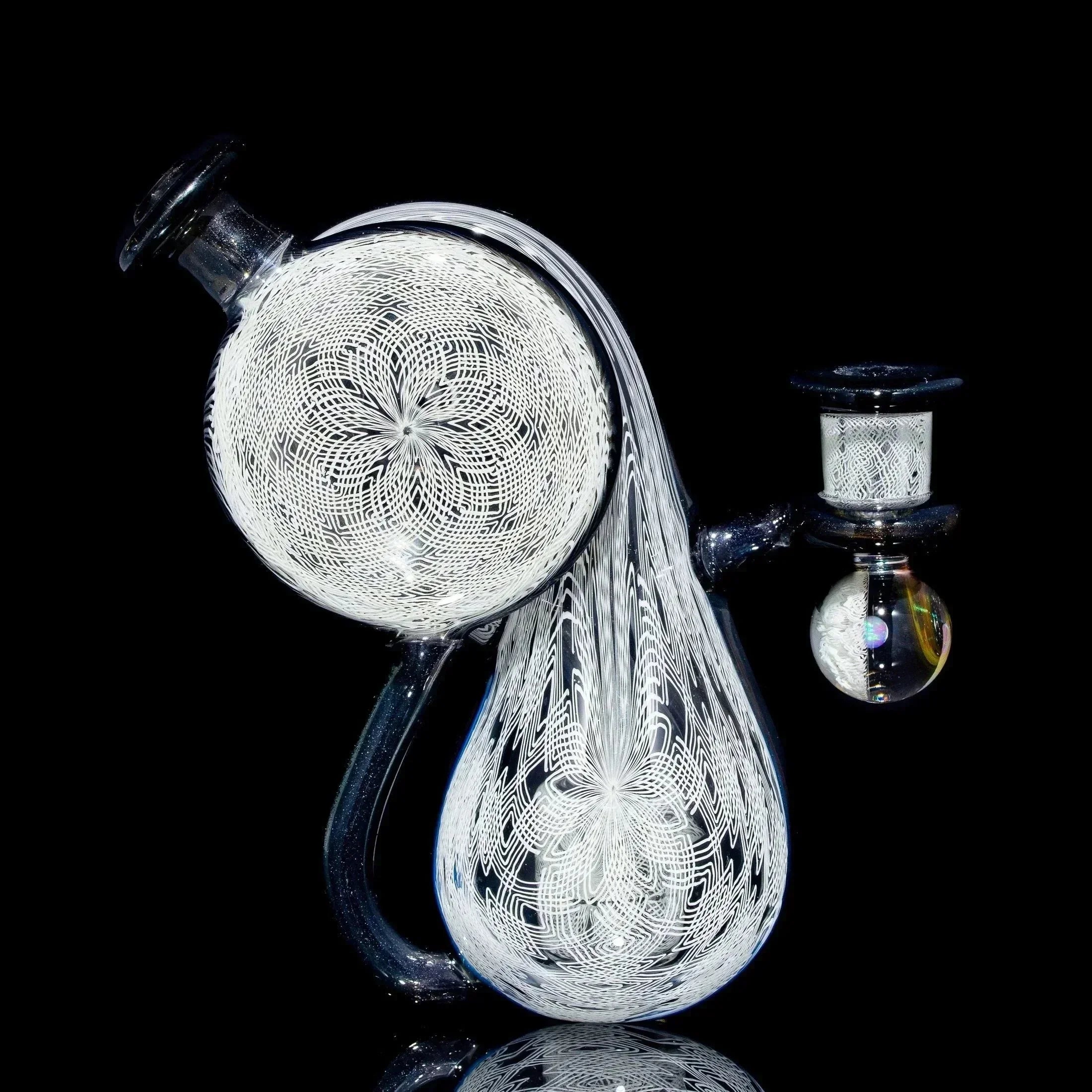 Intricate heady glass water pipe with white lattice pattern on black background