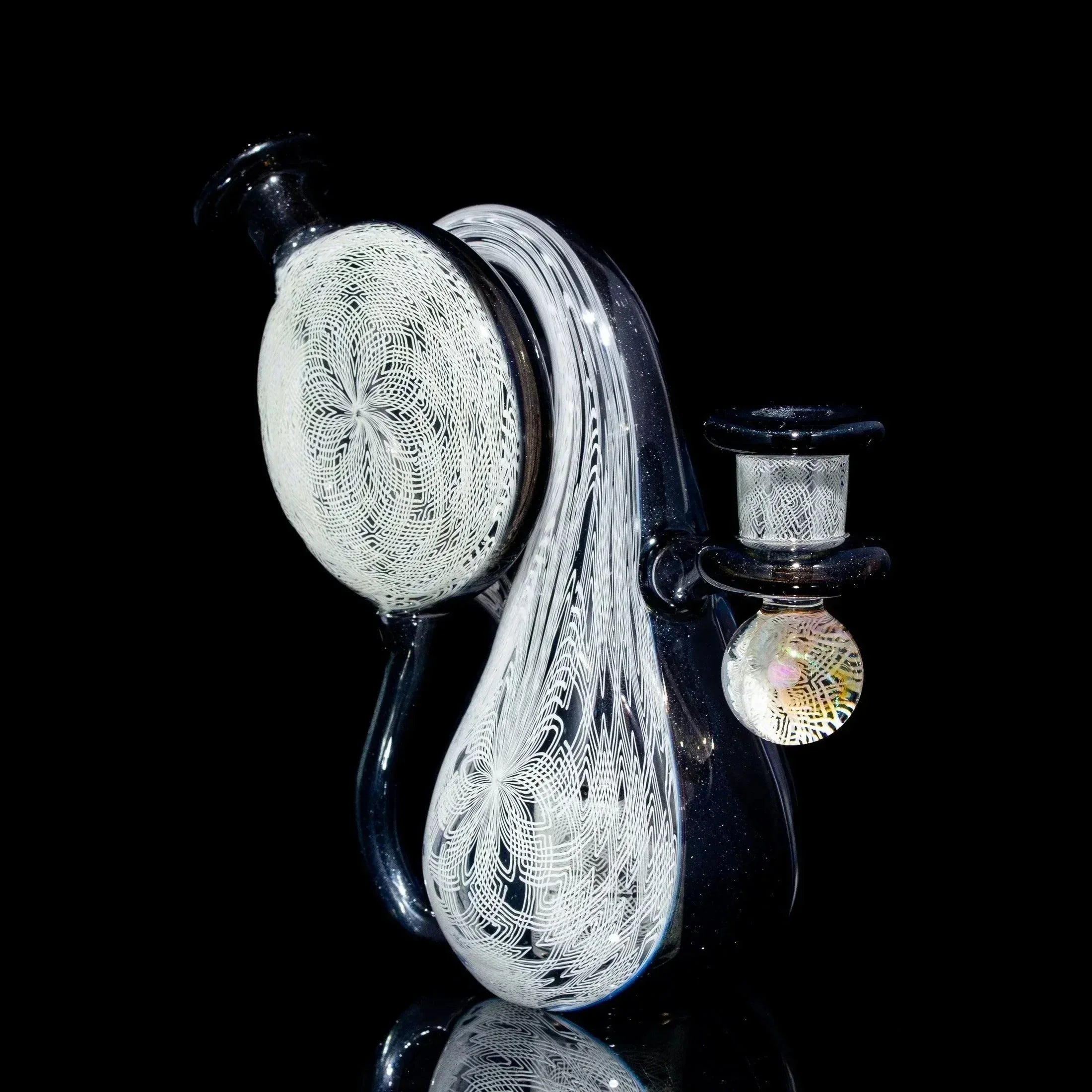 Intricate heady glass water pipe with white spiral designs on black background