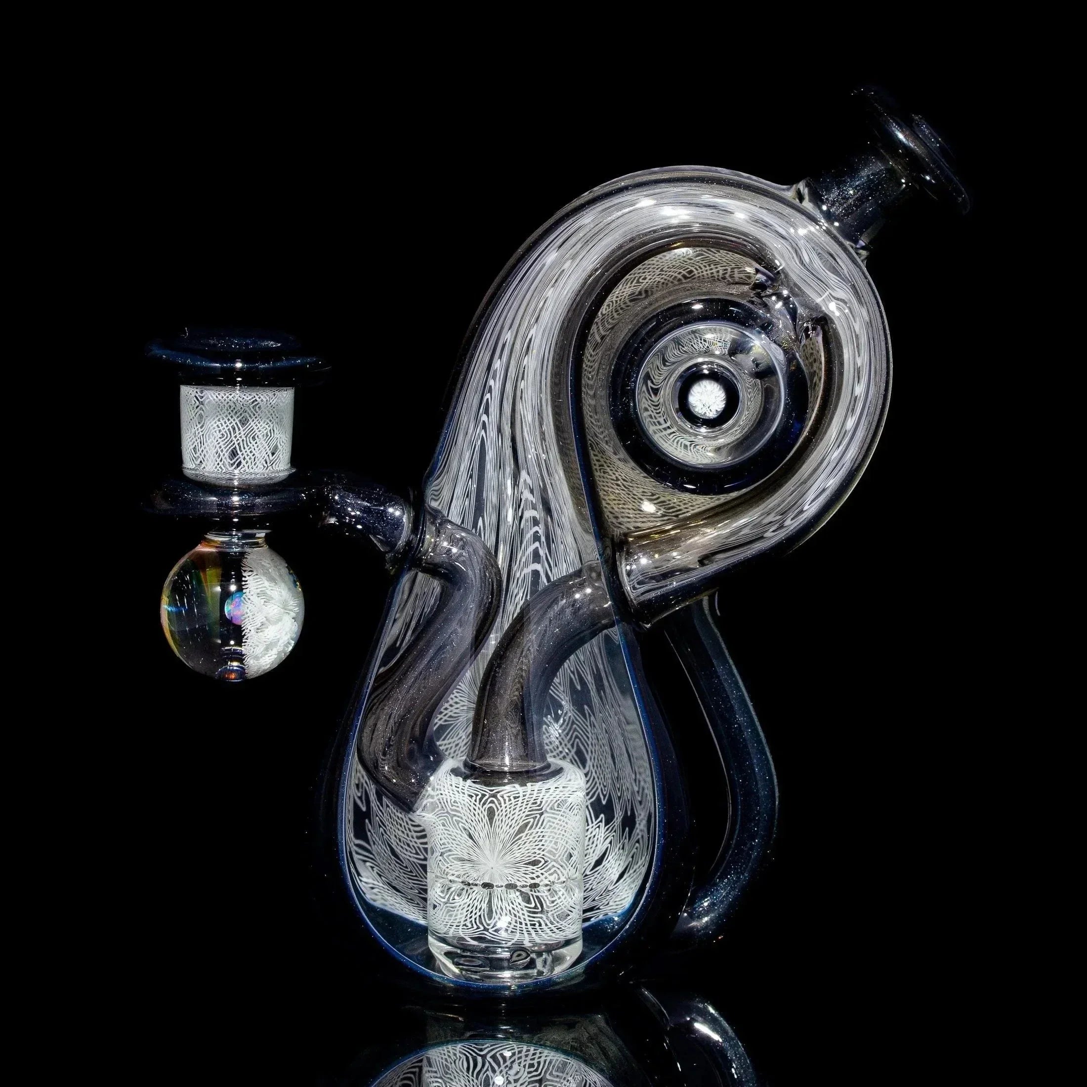 Intricate clear glass water pipe with abstract design and detailed linework on a black background.