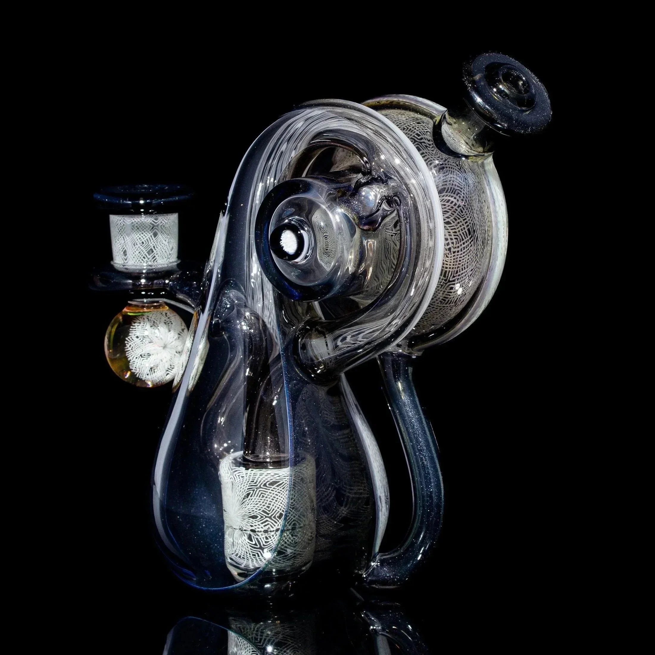 Intricate clear glass water pipe with detailed patterns, displayed on a black background.