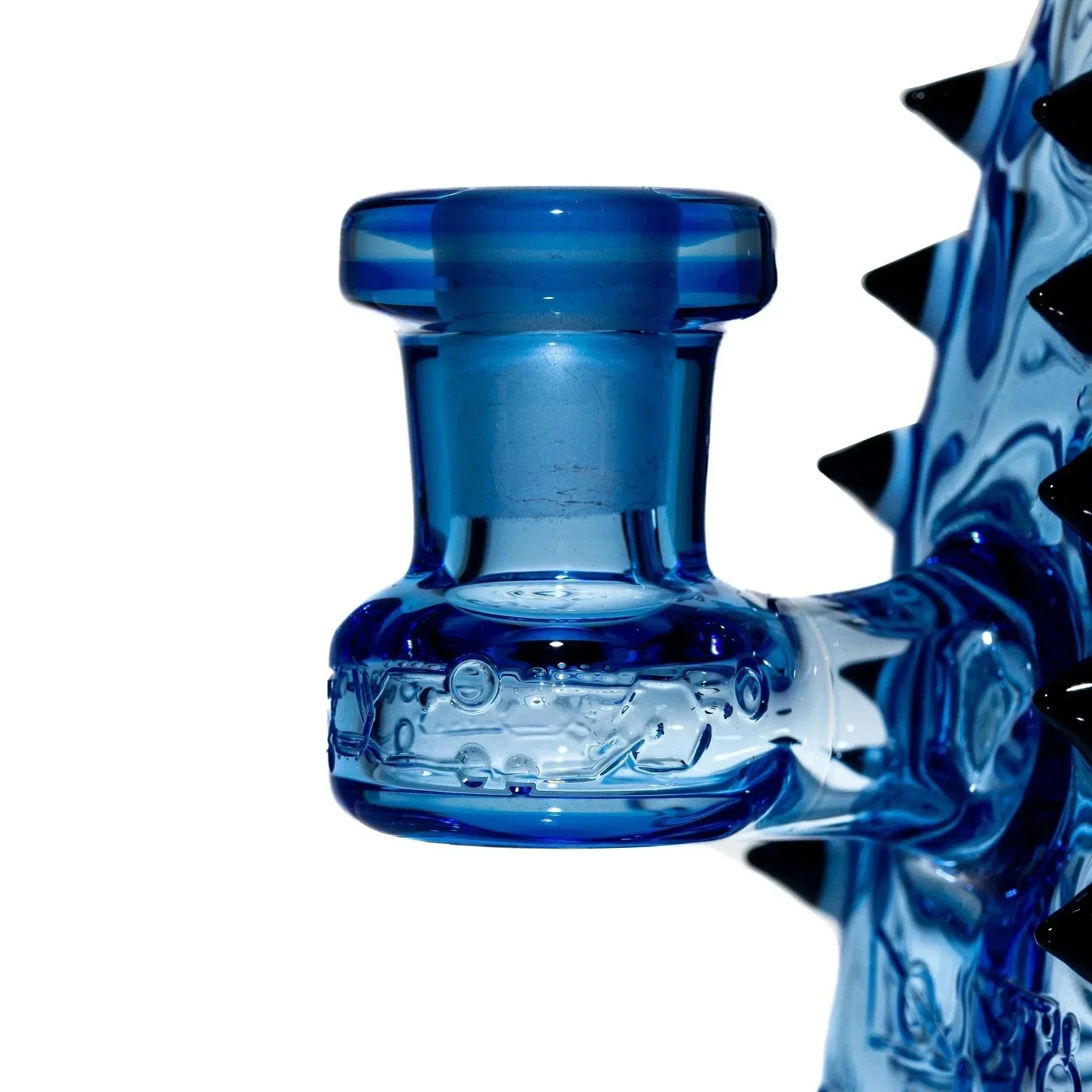 Close-up of a blue glass water pipe with spiked accents, intricate decorative details