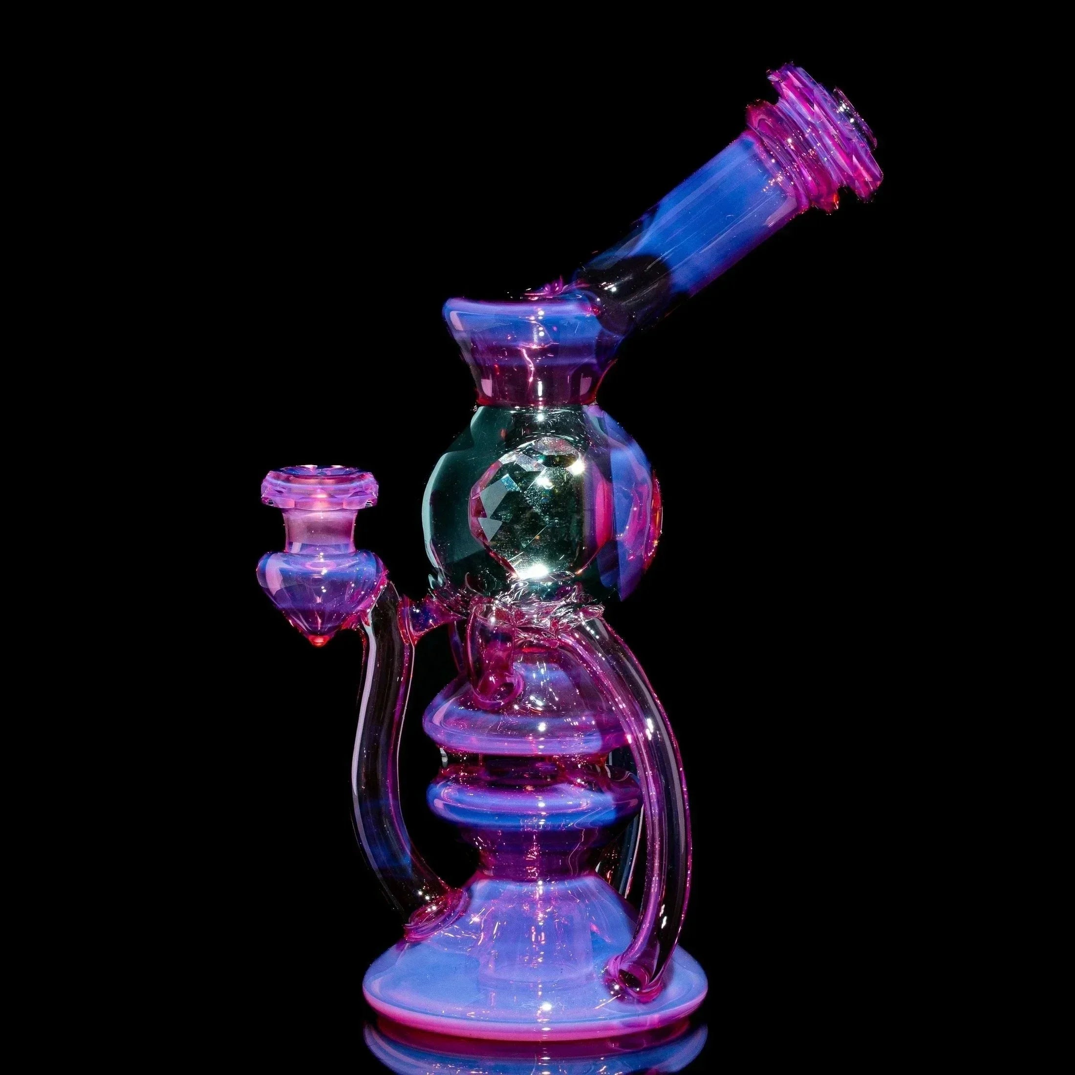 Telemagenta glass orbcycler water pipe with intricate design on black background