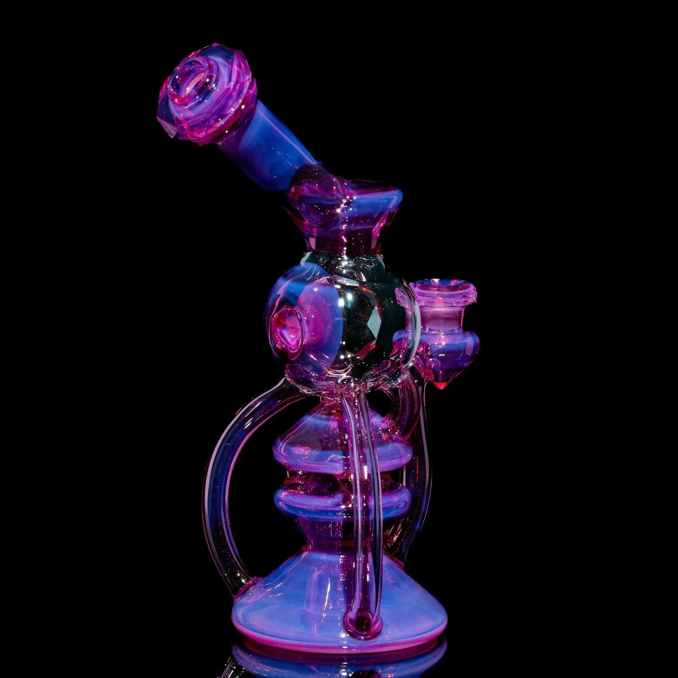 Telemagenta orbcycler heady glass water pipe with sculpted details on black background