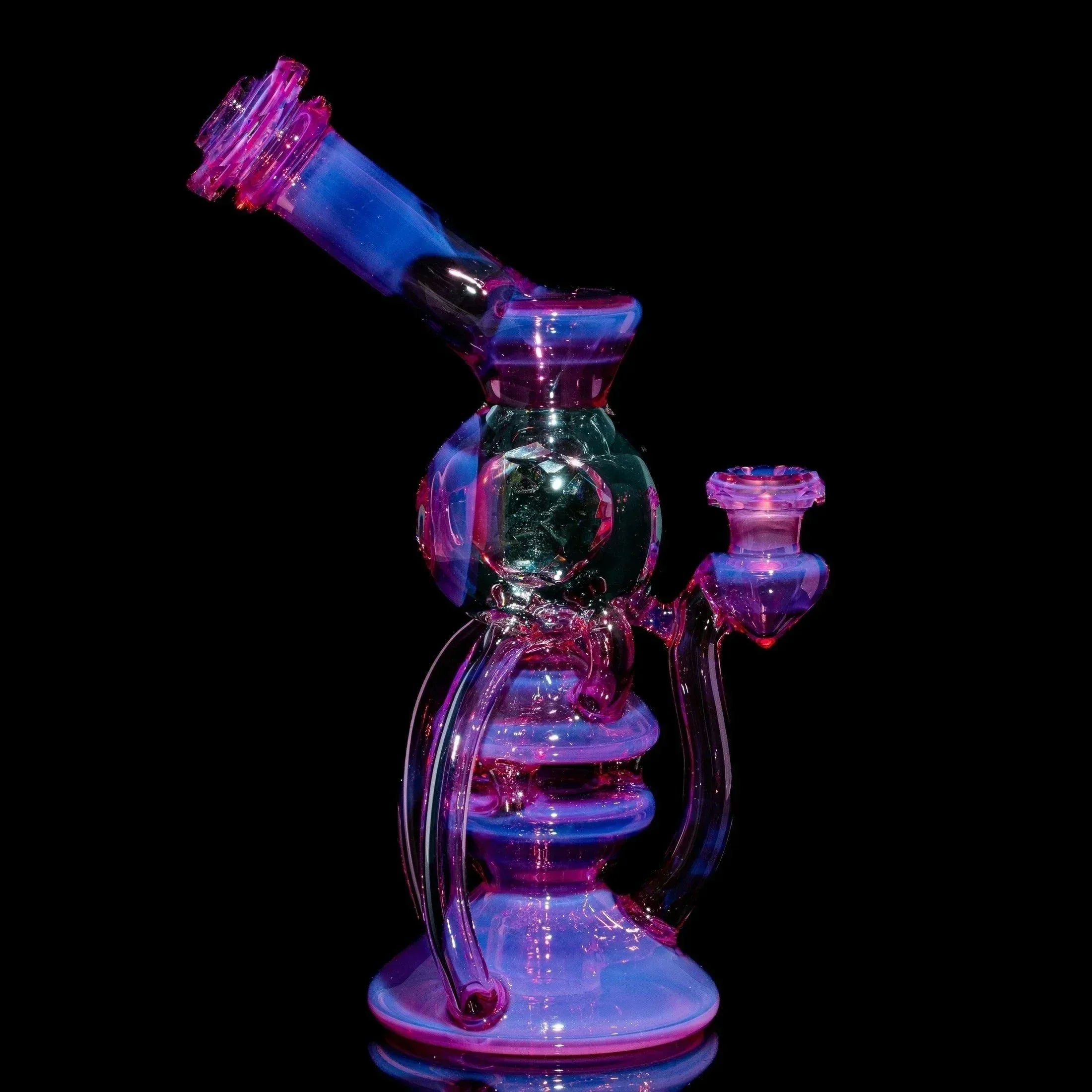 Telemagenta orbcycler glass water pipe with curved design on black background