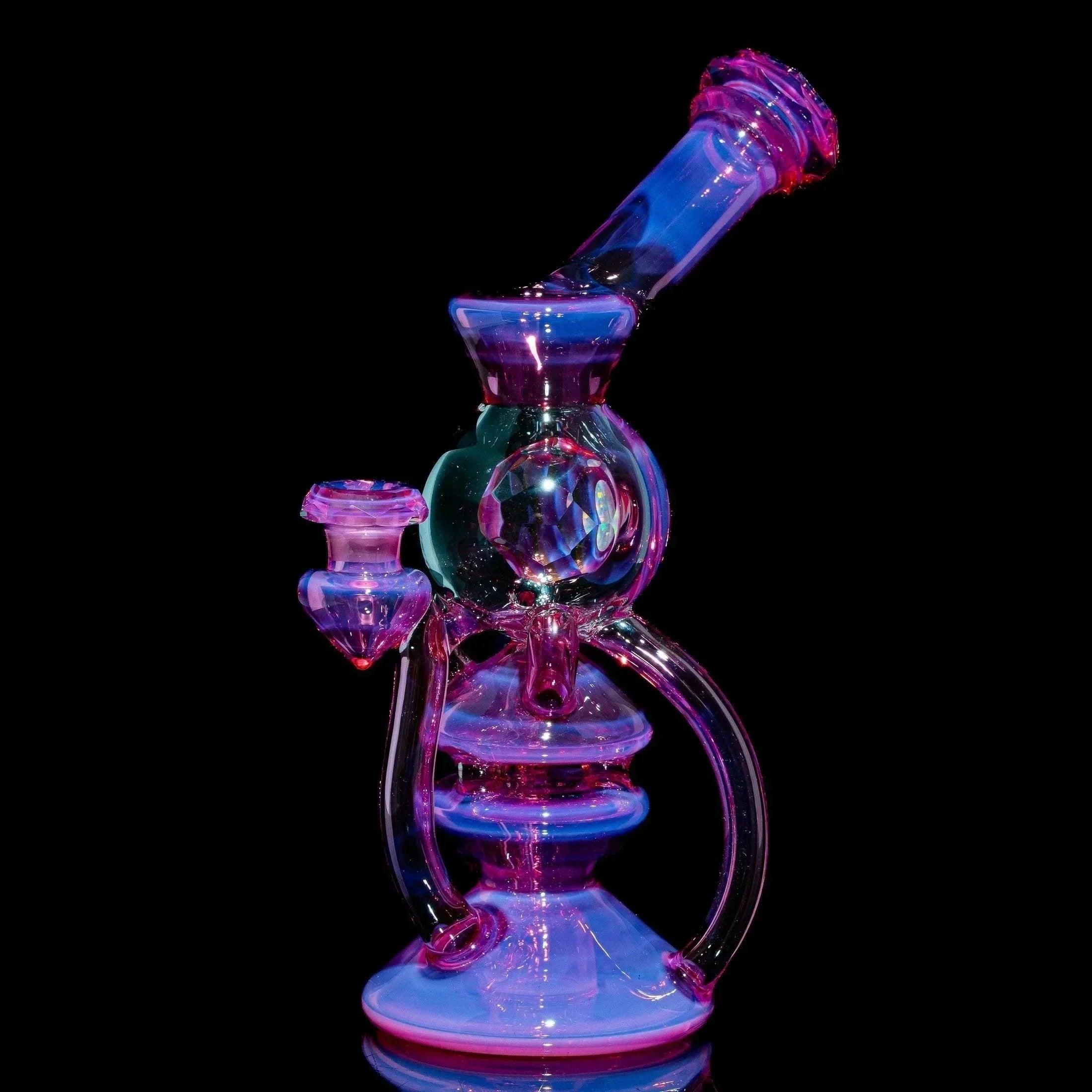 Telemagenta glass orb recycler water pipe with intricate design on black background