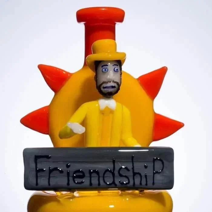 Hand-blown glass figurine of a man in yellow suit with 'Friendship' sign, heady glass art