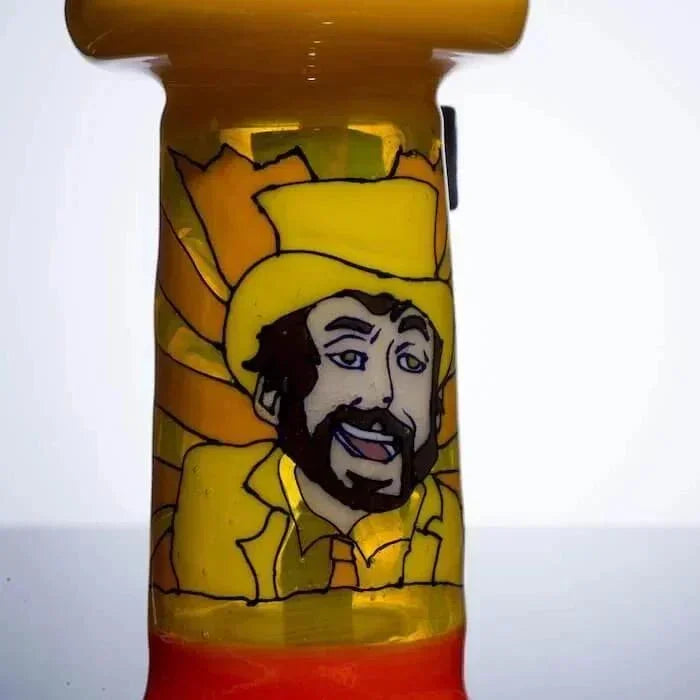 Hand-painted glass pipe with cartoon cowboy, vibrant yellow and orange hues, heady glass art