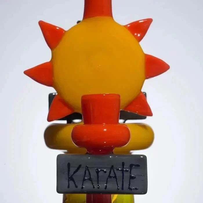 Colorful glass pipe with sun design and 'KARATE' sign, heady glass art for smoke shop