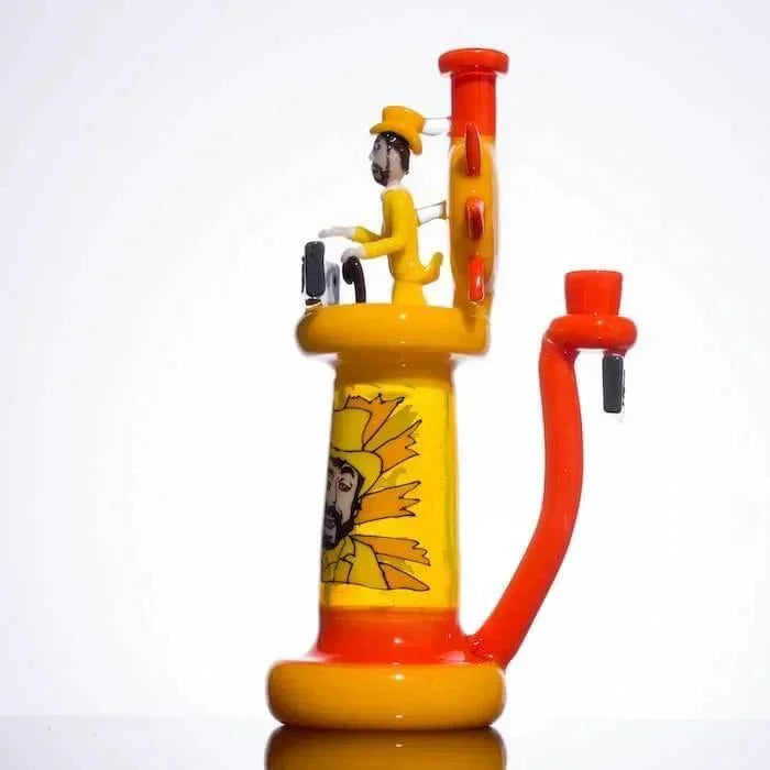 Yellow and orange glass bong with cartoon figure, sunburst design, and curved arm
