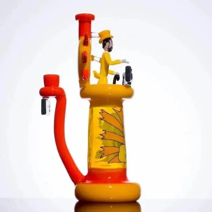 Vibrant yellow and orange glass bong with sunflower design and figurine, heady glass art piece