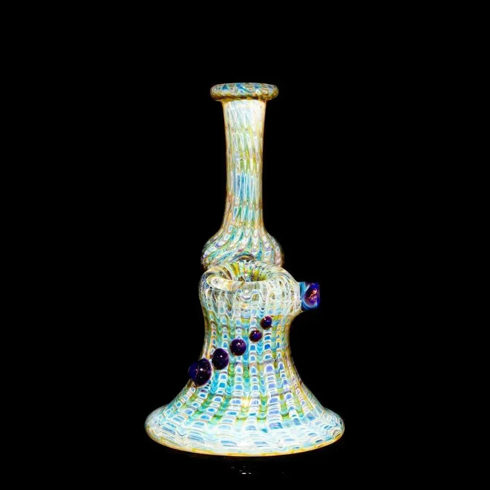 Amber and blue glass water pipe with textured wrap design and decorative marbles, black background.