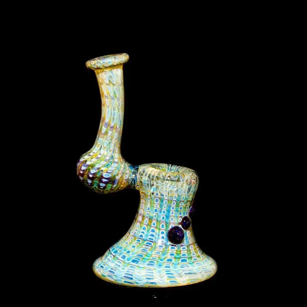 Heady glass bubbler with amber and blue accents, intricate wrap design on black background