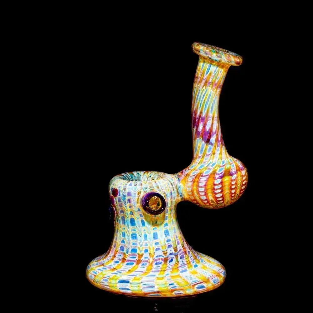 Colorful amber and purple glass bubbler pipe with vortex pattern on a black background