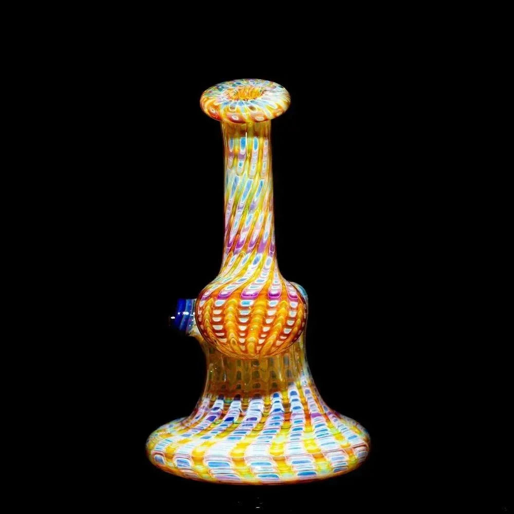 Hand-blown amber and purple glass bubbler with vibrant swirl design on black background