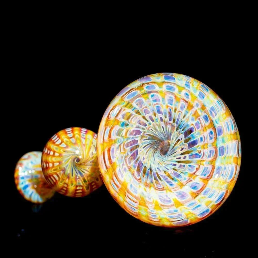 Amber purple glass bubbler pipe with colorful spiral pattern on black background