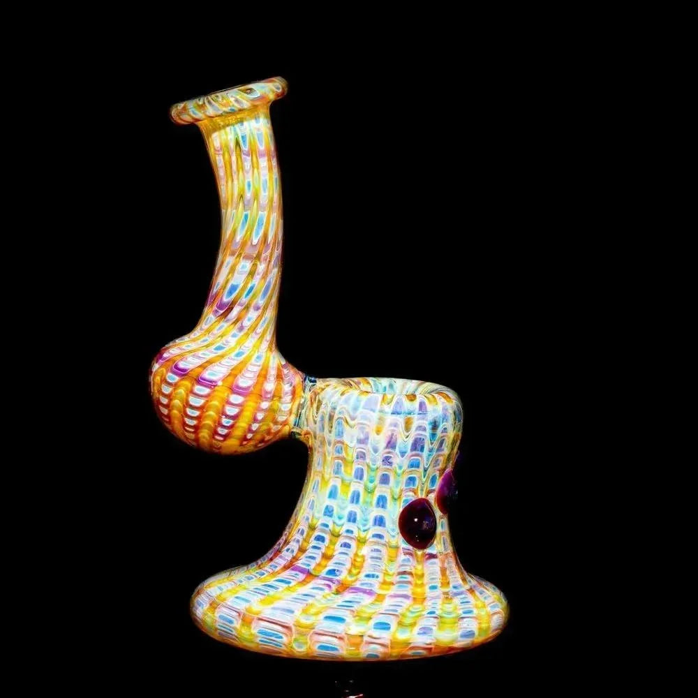 Colorful amber and purple glass bubbler pipe with spiral pattern on black background