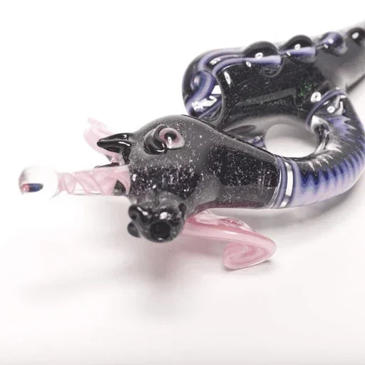 Black and purple glass pipe with pink accents, featuring intricate swirls and a glossy finish.