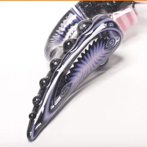 Purple and black heady glass pipe with intricate swirls and bead details