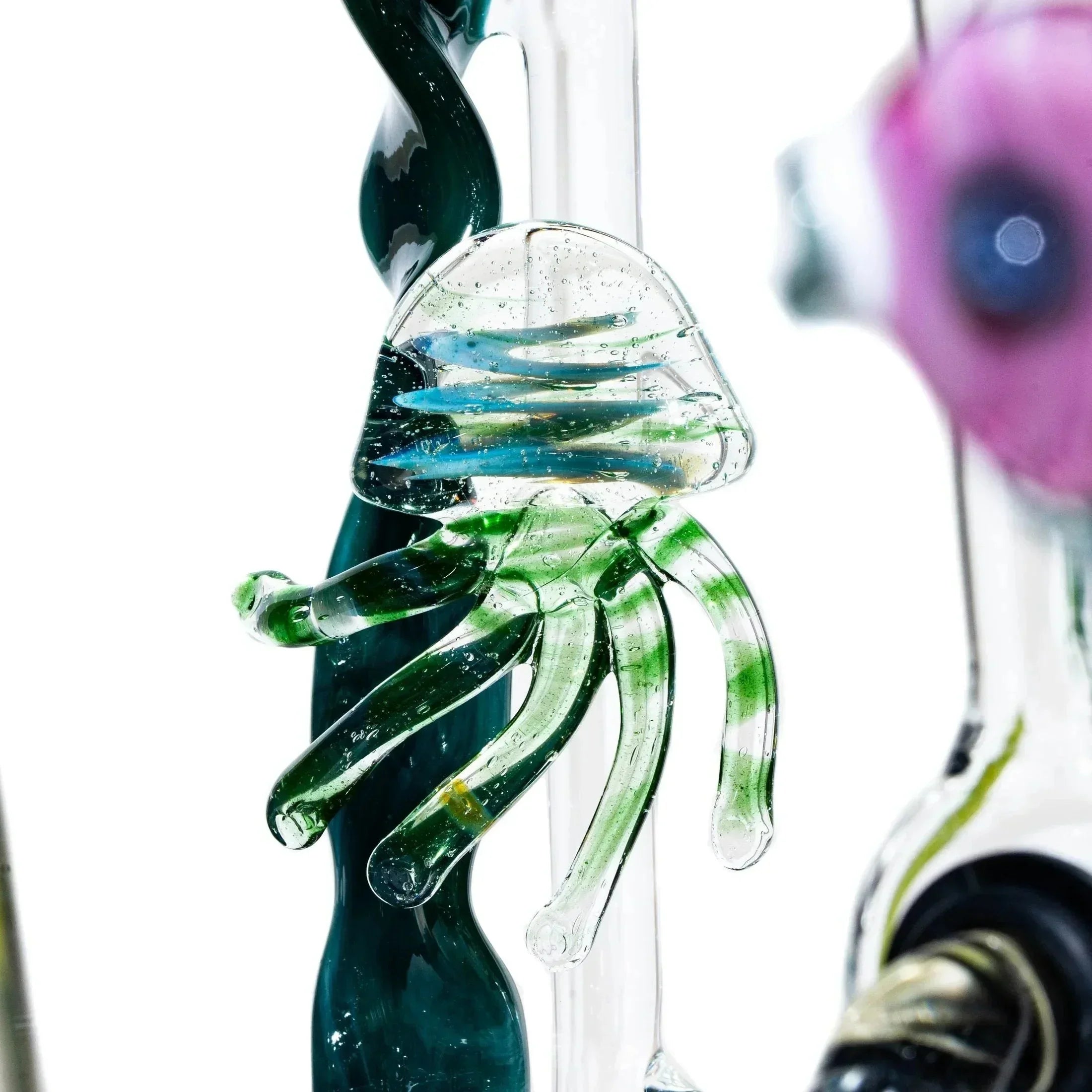 Handblown glass jellyfish sculpture with colorful tentacles in a kinetic art piece