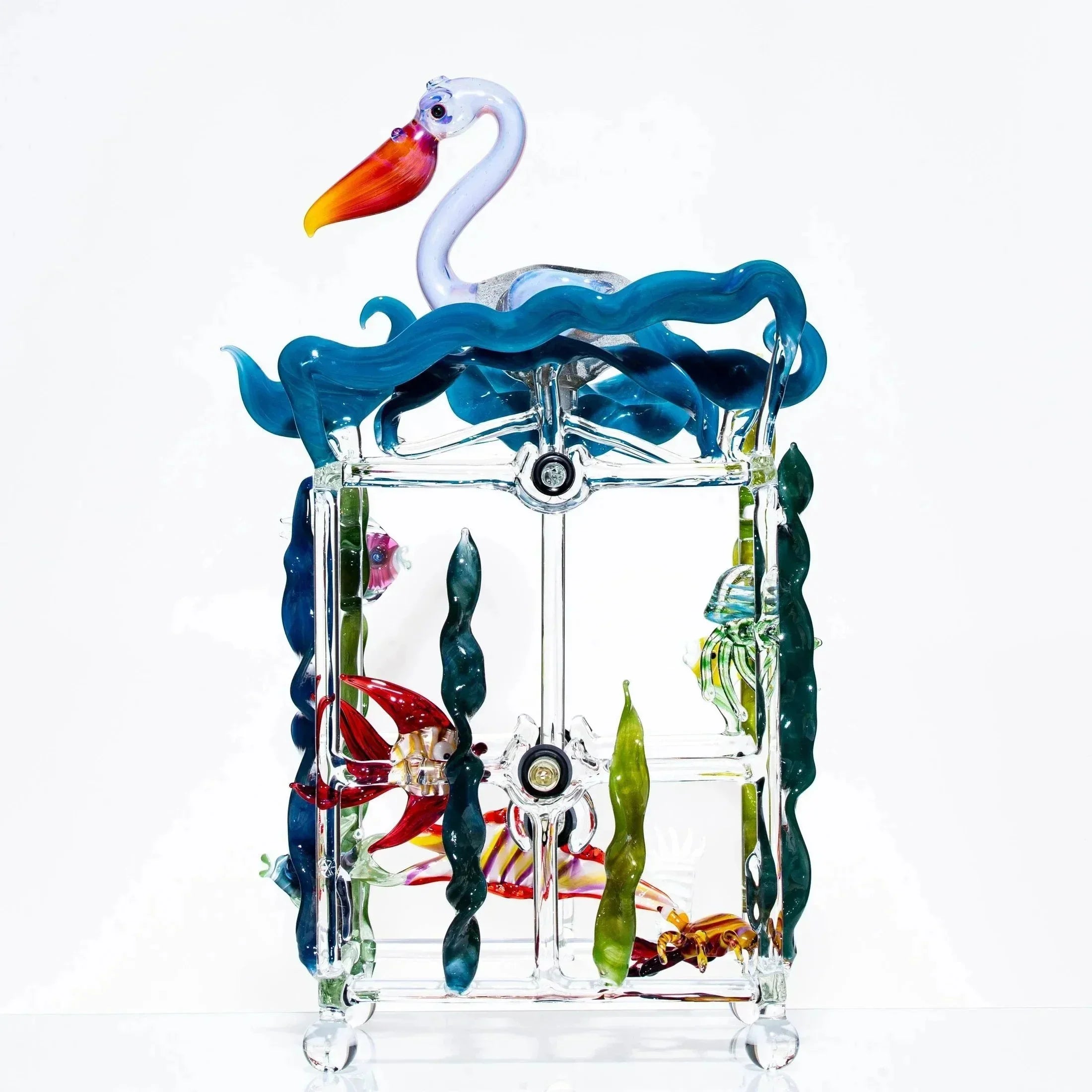 Hand-blown glass kinetic sculpture with colorful sea life and a pelican on blue waves