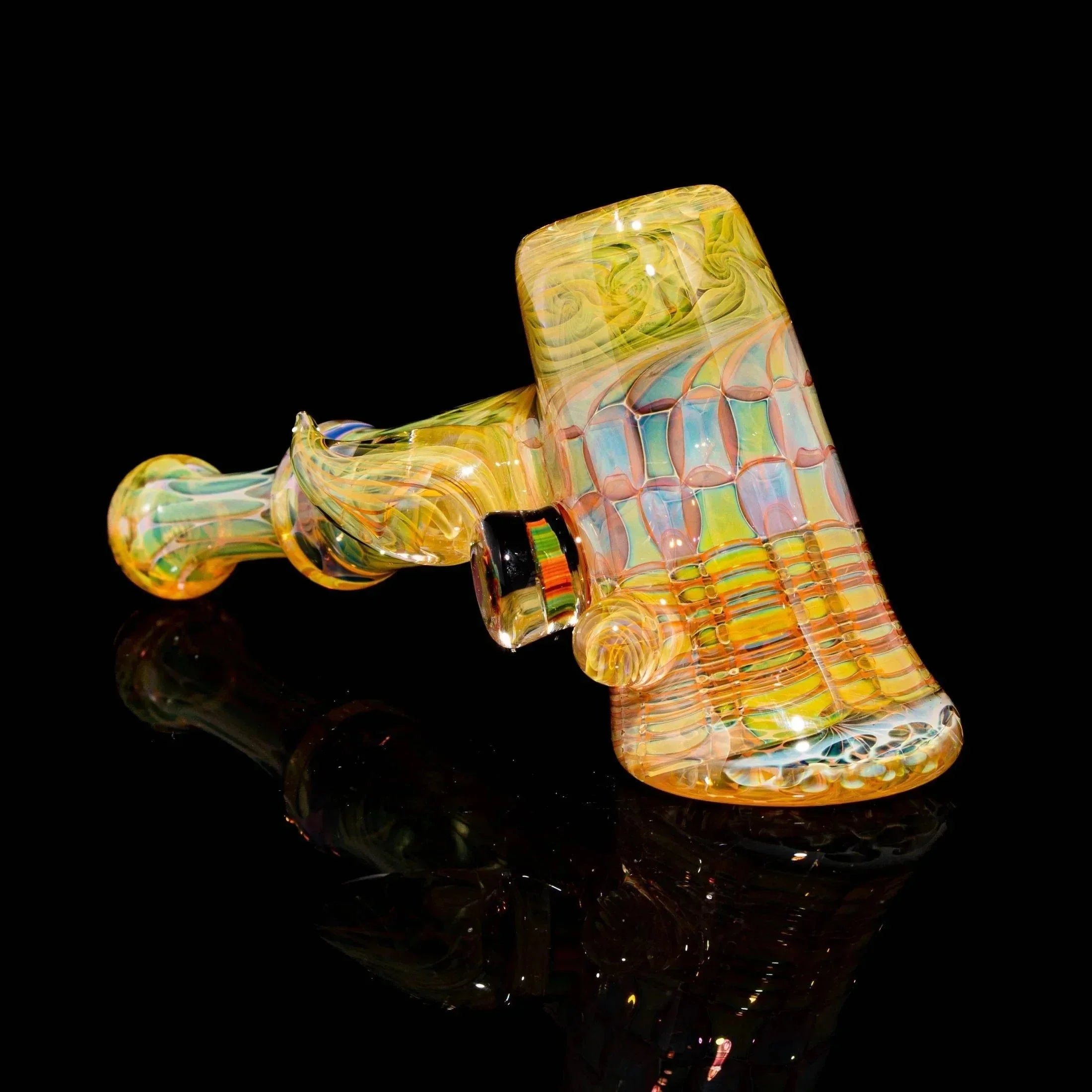 Colorful heady glass hammer pipe with swirling patterns on a black background