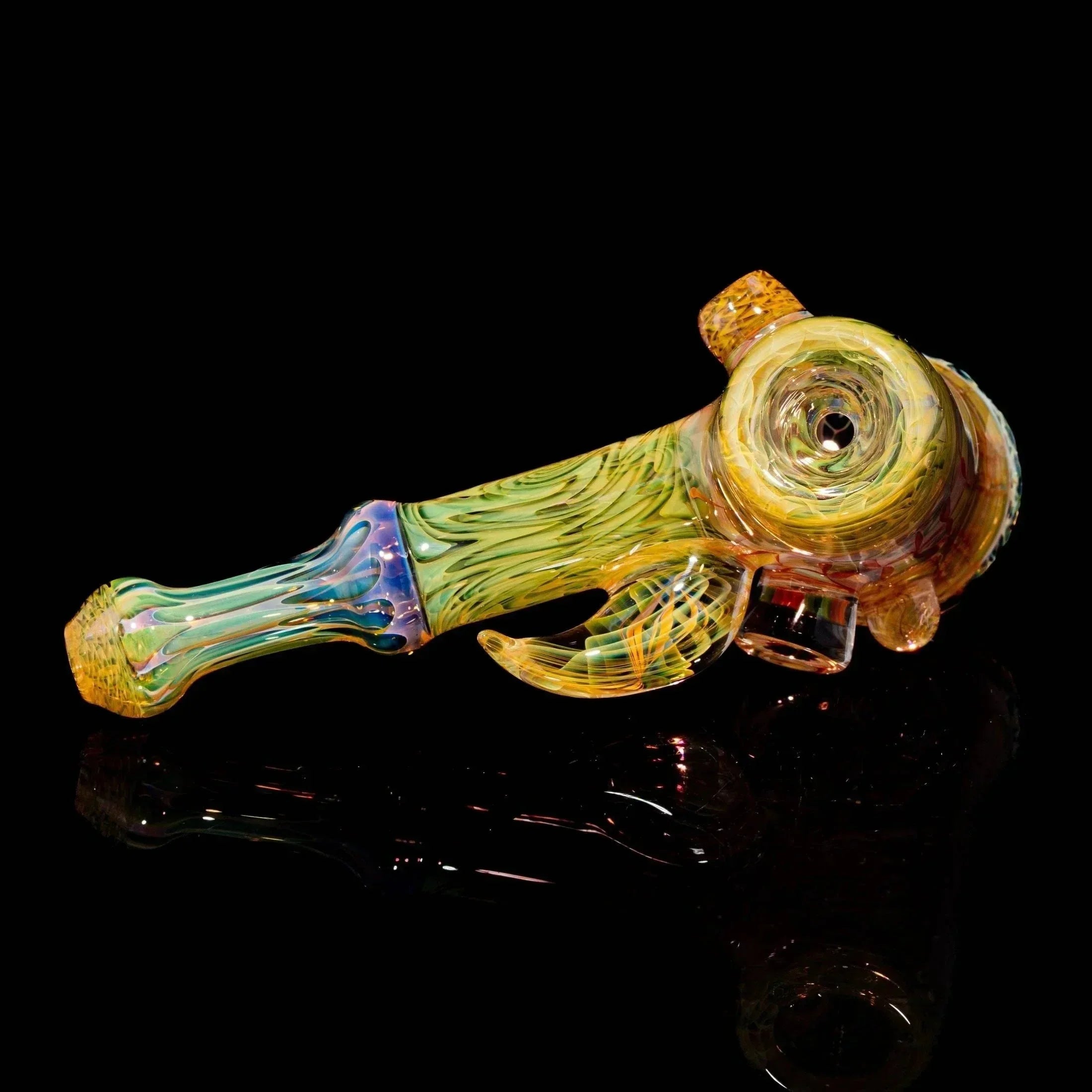 Heady glass hand pipe with colorful swirled patterns on a black background