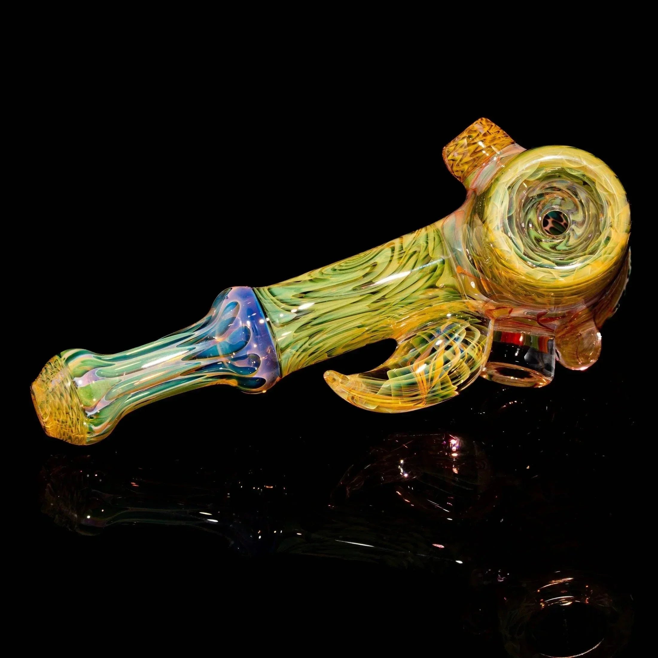 Colorful hand-blown glass pipe with intricate yellow and green swirling patterns