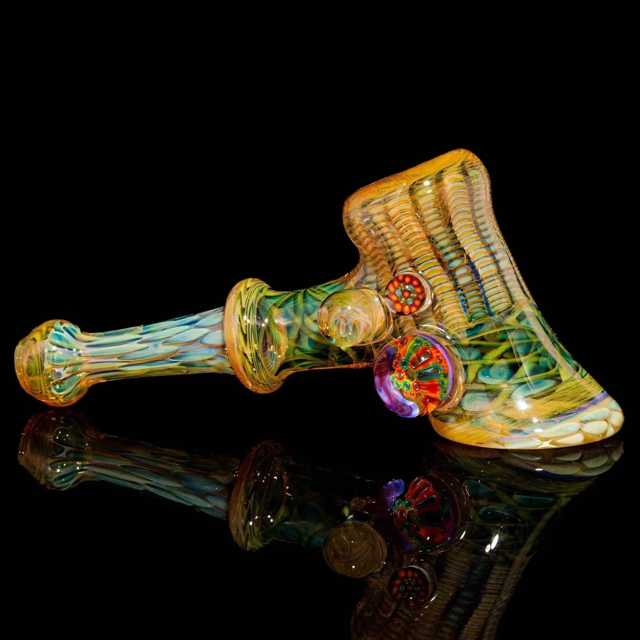 Handblown glass hammer pipe with colorful intricate patterns and marble accents on black background
