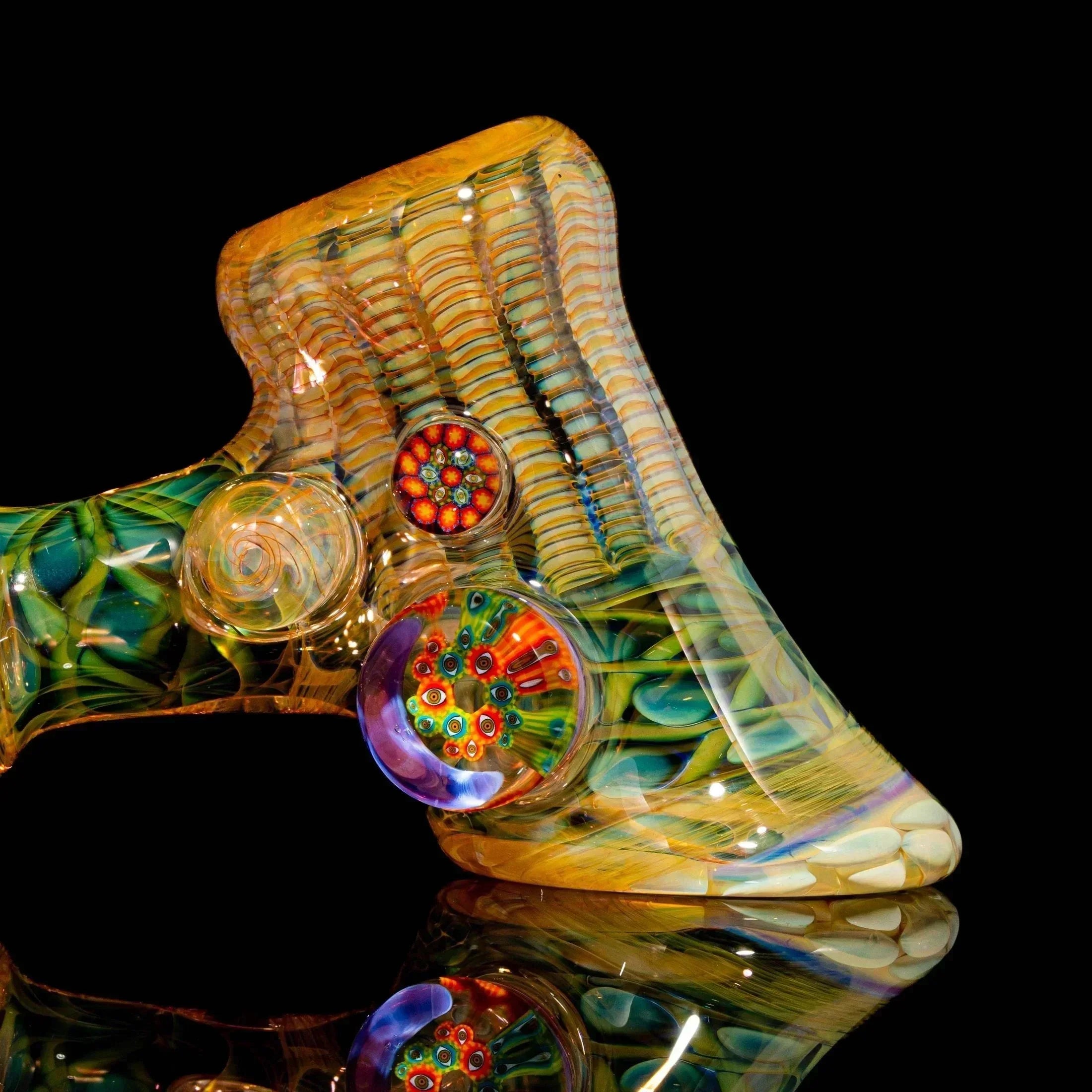 Colorful glass hand pipe with intricate patterns and vibrant millefiori details on black background