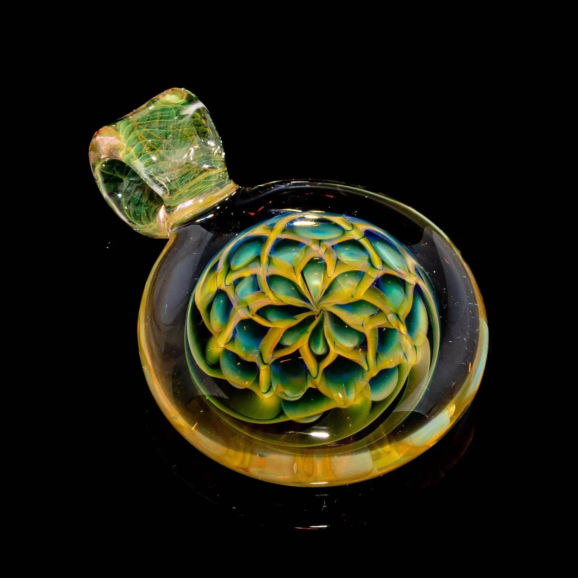 Handmade glass pendant with intricate green and yellow flower design on black background