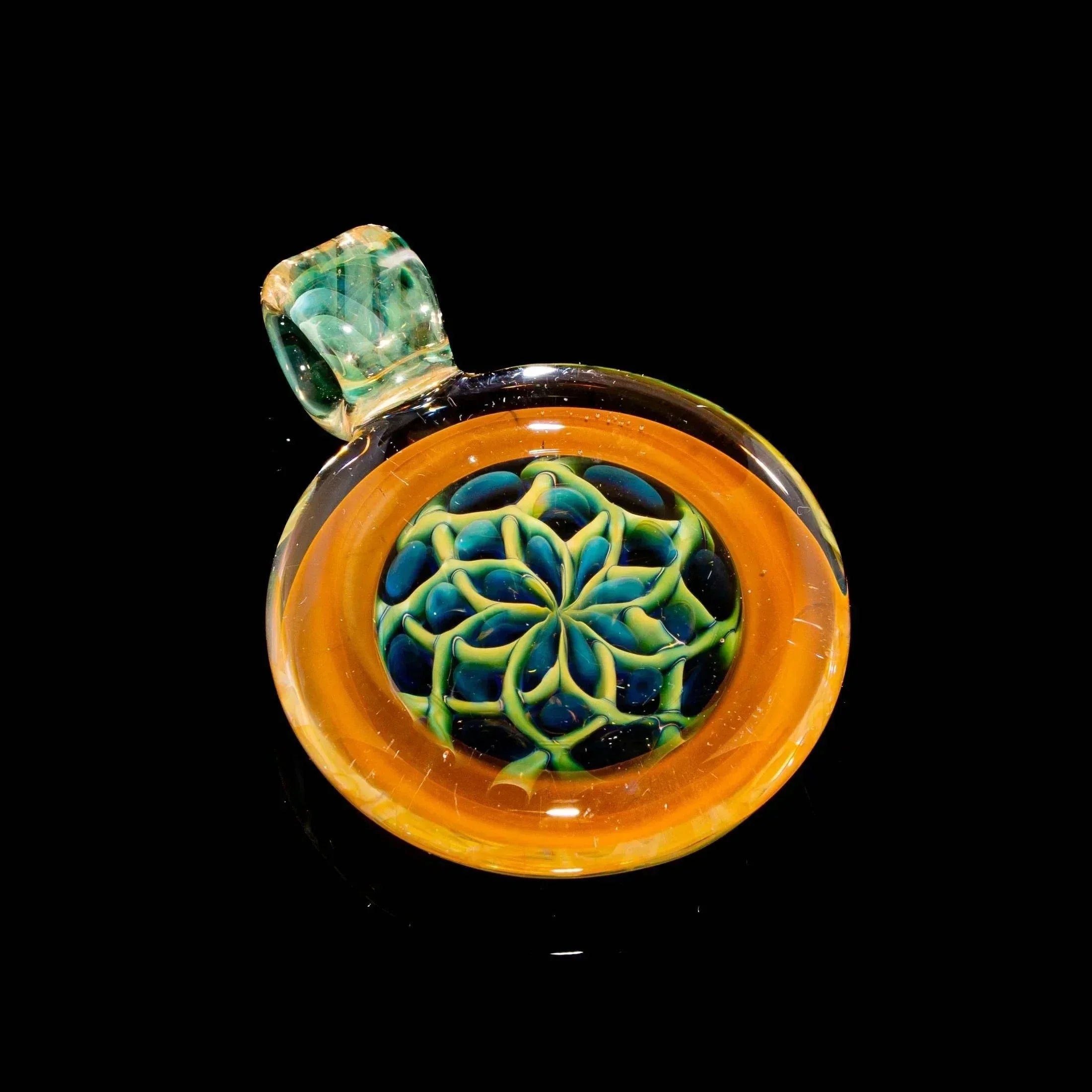 Hand-blown glass pendant with vibrant blue and green flower design on orange background