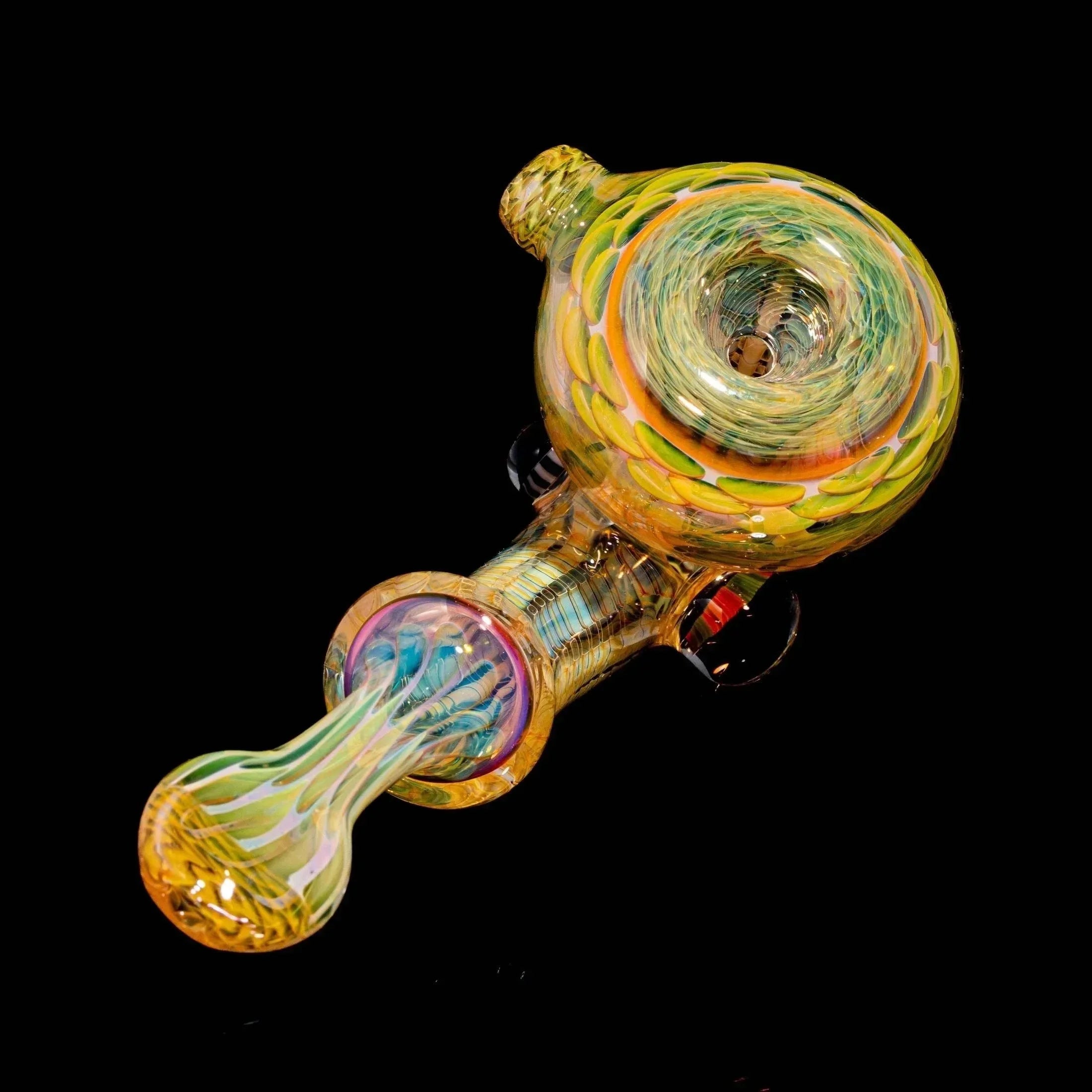 Colorful hand-blown glass pipe with intricate swirl design on black background