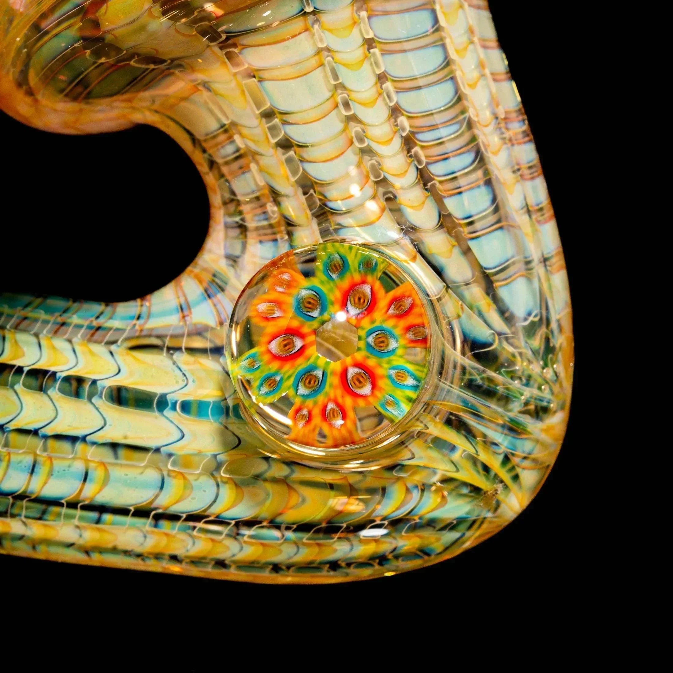 Intricate heady glass pipe with colorful patterned marble and lattice detail on black background.