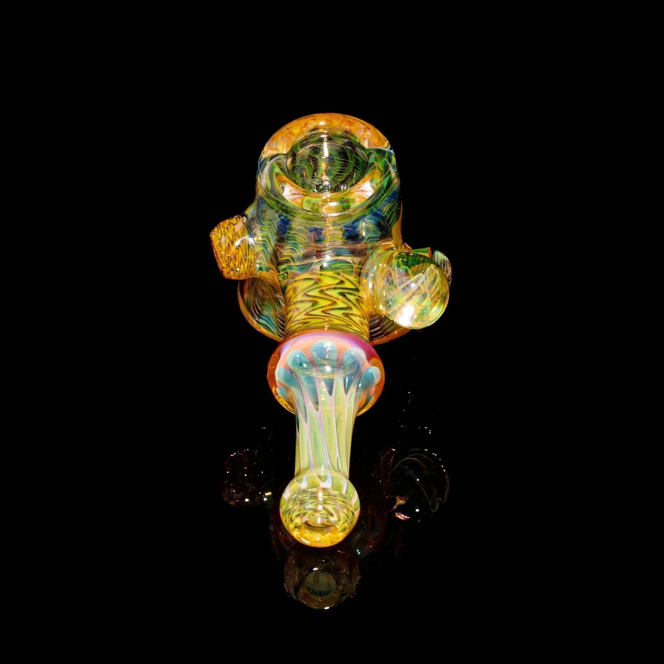 Colorful heady glass hand pipe with intricate patterns on black background