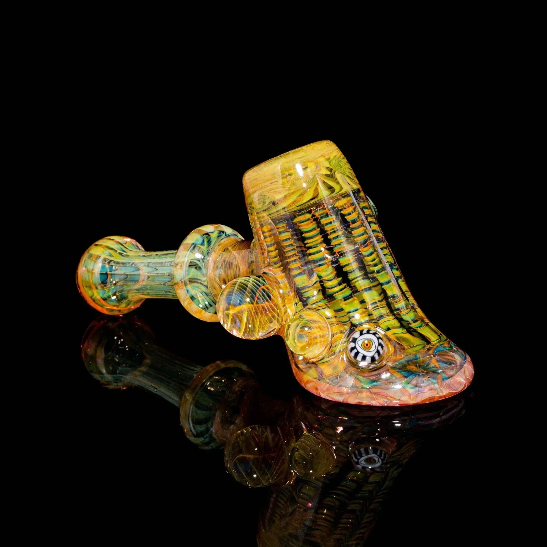 Intricately designed colorful glass hand pipe with detailed patterns on black background