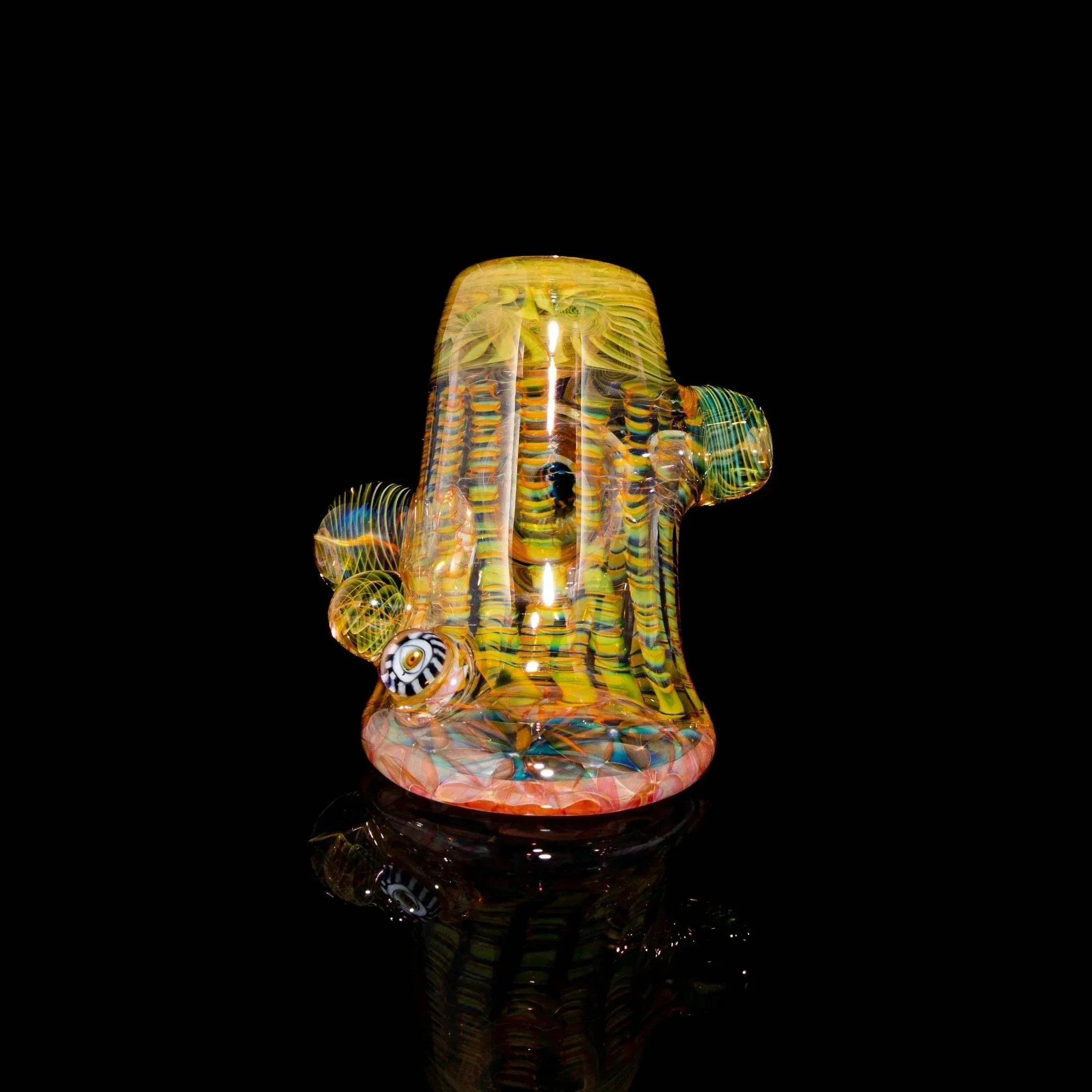 Heady glass water pipe with colorful patterns and intricate designs on black background