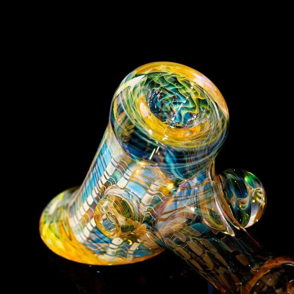 Colorful heady glass hand pipe with intricate swirling patterns on a black background