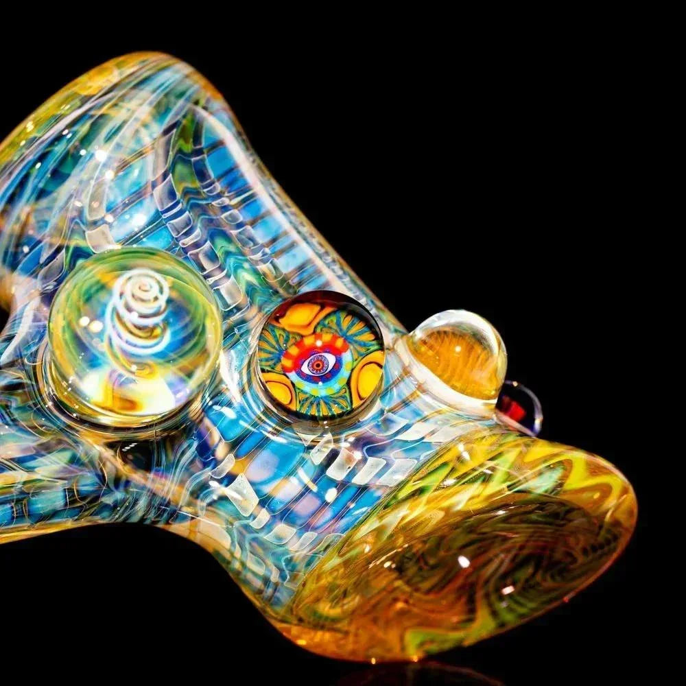 Colorful heady glass pipe with intricate patterns and vibrant marbles on black background