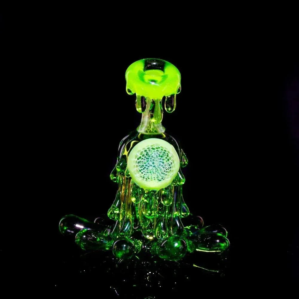 Neon green glass dab rig with drip design and honeycomb detail on black background
