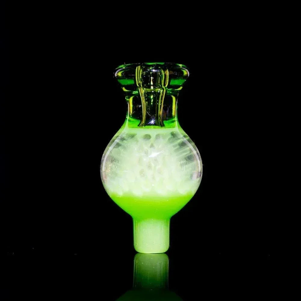 Green glass carb cap with bulbous shape and clear textured detailing on black background