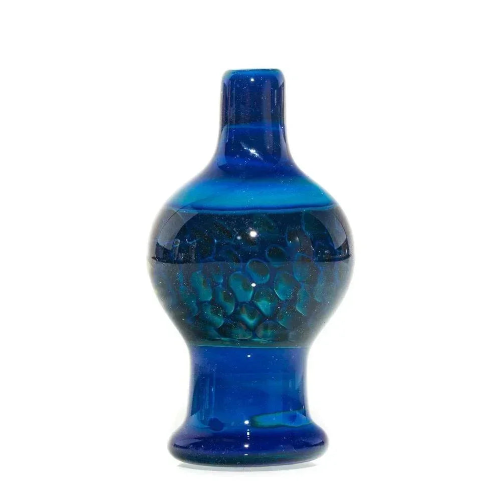 Hand-blown intense blue and green glass bubble cap with textured details on white background.
