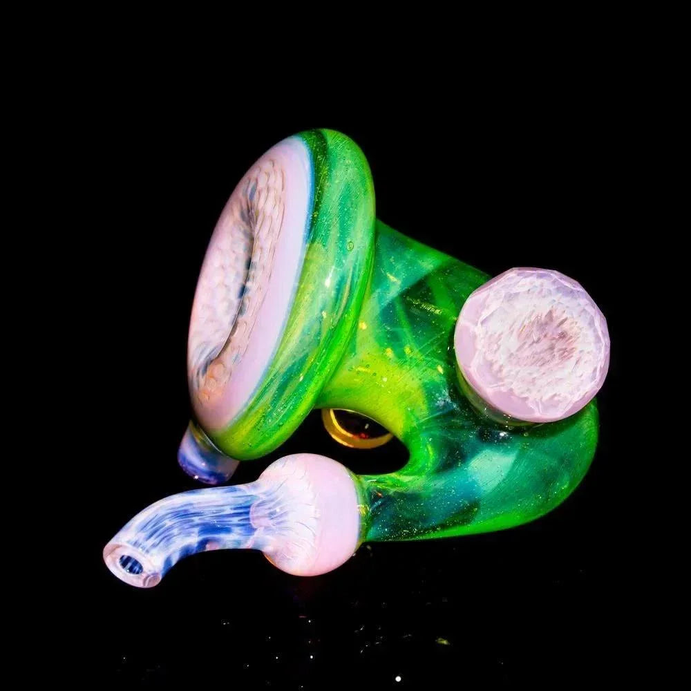 Green and pink faceted honeycomb Sherlock glass pipe with textured accents on black background